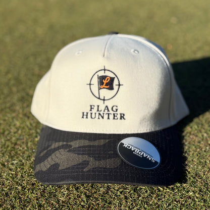 Cream and Camo Cap with 'Flag Hunter' logo on a grassy background