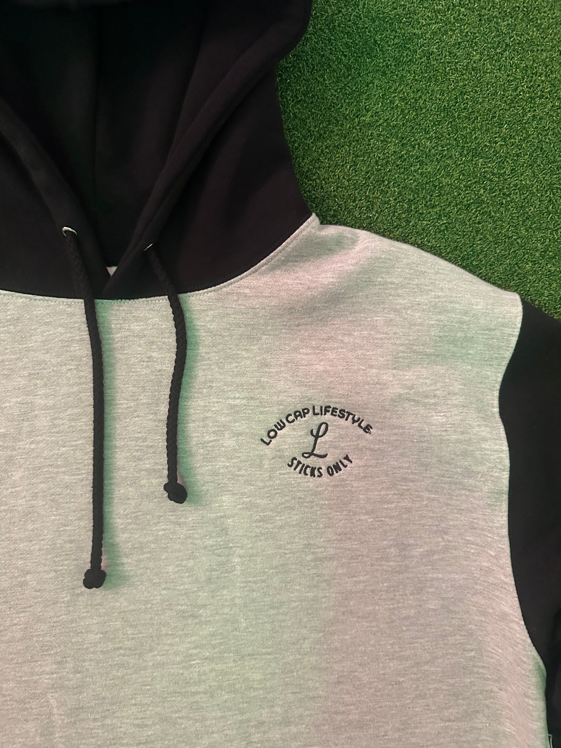 2 tone Heavy weight slotter hoodie. Close up of small logo on chest that says Low Cap Lifestyle Sticks Only 