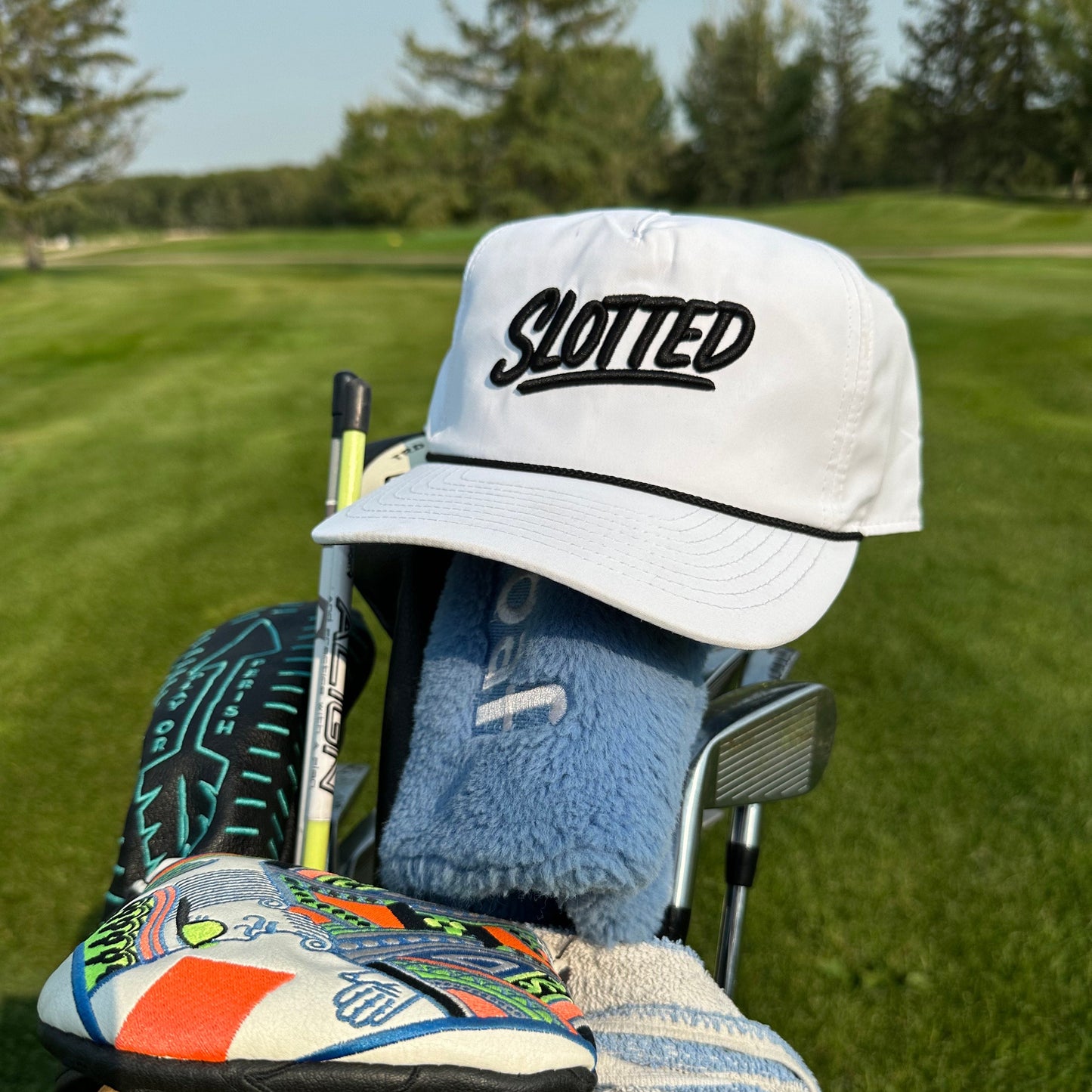 Slotted Cash piece hat. White with black embroidery 